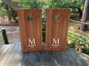 Custom rustic wedding cornhole boards featuring a wood plank background with a personalized monogram and last name. Perfect for elegant outdoor weddings, receptions, and anniversary celebrations Custom rustic wedding cornhole boards featuring a wood plank background with a personalized monogram and last name. Perfect for elegant outdoor weddings, receptions, and anniversary celebrations