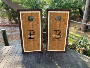 Custom rustic monogram cornhole boards featuring a rich woodgrain background, elegant border, and personalized initial with an established date. Perfect for weddings, family gatherings, and farmhouse decor. Custom rustic monogram cornhole boards featuring a rich woodgrain background, elegant border, and personalized initial with an established date. Perfect for weddings, family gatherings, and farmhouse decor.