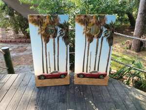 Custom car-themed cornhole boards featuring a red sports car parked under tall palm trees with a scenic sunset sky. Perfect for car enthusiasts, auto lovers, and outdoor gathering Custom car-themed cornhole boards featuring a red sports car parked under tall palm trees with a scenic sunset sky. Perfect for car enthusiasts, auto lovers, and outdoor gathering