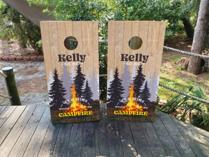 Custom campfire-themed cornhole boards featuring a rustic wood background, glowing fire, silhouetted pine trees, and personalized name. Perfect for camping enthusiasts, outdoor retreats, and backyard bonfire games. Custom campfire-themed cornhole boards featuring a rustic wood background, glowing fire, silhouetted pine trees, and personalized name. Perfect for camping enthusiasts, outdoor retreats, and backyard bonfire games.