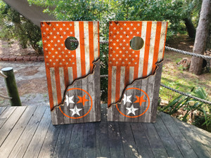 Cornhole wraps featuring a dual USA flag and TN Tristar flag, both in orange and on a woodgrain background
