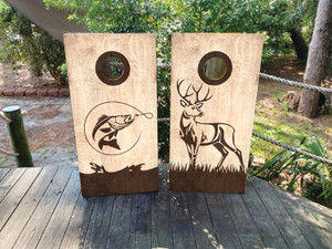 These cornhole wraps feature a natural, wood-grain background with outdoor-themed silhouettes. One wrap showcases a detailed outline of a fish mid-leap, hooked on a fishing line, with waves at the bottom. The other wrap displays a majestic deer standing tall in a grassy field. The minimalist, nature-inspired designs are perfect for outdoor enthusiasts, combining the love of fishing and hunting with a rustic, earthy aesthetic that complements the wood texture. Ideal for game setups at nature retreats or outdoor gatherings. These cornhole wraps feature a natural, wood-grain background with outdoor-themed silhouettes. One wrap showcases a detailed outline of a fish mid-leap, hooked on a fishing line, with waves at the bottom. The other wrap displays a majestic deer standing tall in a grassy field. The minimalist, nature-inspired designs are perfect for outdoor enthusiasts, combining the love of fishing and hunting with a rustic, earthy aesthetic that complements the wood texture. Ideal for game setups at nature retreats or outdoor gatherings.