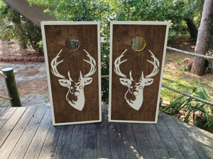 These cornhole wraps feature a simple yet striking design with a woodgrain background and a white silhouette of a deer's head with large antlers in the center. The rustic wood texture combined with the clean white outline creates a natural, outdoorsy feel, perfect for hunting enthusiasts or those who appreciate wildlife. The minimalistic design is framed by a white border, enhancing the contrast and giving the wraps a polished, stylish appearance. Ideal for outdoor gatherings or nature-themed events. These cornhole wraps feature a simple yet striking design with a woodgrain background and a white silhouette of a deer's head with large antlers in the center. The rustic wood texture combined with the clean white outline creates a natural, outdoorsy feel, perfect for hunting enthusiasts or those who appreciate wildlife. The minimalistic design is framed by a white border, enhancing the contrast and giving the wraps a polished, stylish appearance. Ideal for outdoor gatherings or nature-themed events.