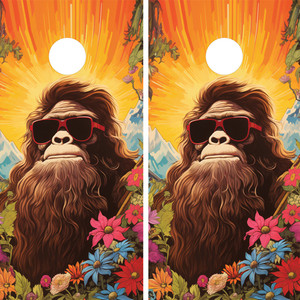 "Two cornhole board wraps featuring a playful Bigfoot character wearing red sunglasses, surrounded by vibrant wildflowers and greenery, set against a bright sunrise with colorful mountains in the background, with a white scoring hole near the top of each board." "Two cornhole board wraps featuring a playful Bigfoot character wearing red sunglasses, surrounded by vibrant wildflowers and greenery, set against a bright sunrise with colorful mountains in the background, with a white scoring hole near the top of each board."