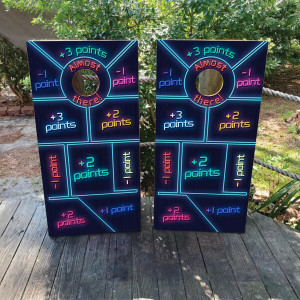 Neon-themed cornhole board design with vibrant point zones labeled from “+3 points” to “-1 point,” and a center circle marked “Almost there!” Each section is color-coded with glowing LED-style text for a fun, arcade-like party game atmosphere.