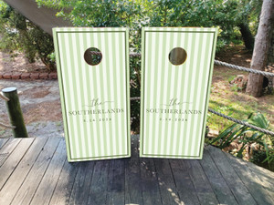 Soft green and ivory striped wedding cornhole board wraps featuring elegant script text reading “The Southerlands – 3.14.2026.” The minimalist double-border design and subtle pastel tones create a timeless, classic look perfect for spring weddings, garden receptions, or outdoor celebrations.