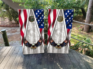 Patriotic design featuring a flying bald eagle with spread wings, rustic gray wood background, flowing American flag stripes, and blue star panel framing the sides.