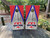 Custom sports team cornhole boards featuring a bold red, white, and blue design with a customizable team logo and text. Perfect for tailgates, game days, and sports fans