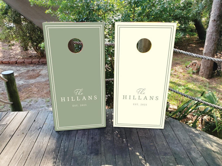 Modern olive green and cream wedding cornhole board wraps featuring elegant minimalist typography that reads “The Hillans – Est. 2025.” A sophisticated and timeless design perfect for wedding receptions, engagement parties, or anniversary celebrations, blending natural tones with a clean, classic aesthetic.