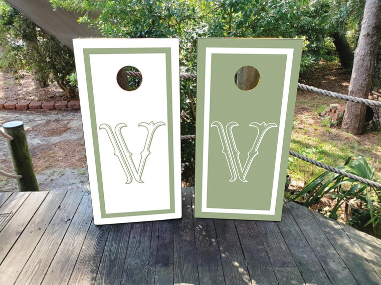 Olive green and ivory wedding cornhole board wraps featuring a refined double-line border and elegant vintage monogram “W” in the center. A minimalist yet timeless design that adds a sophisticated touch to outdoor weddings, garden receptions, and anniversary celebrations.
