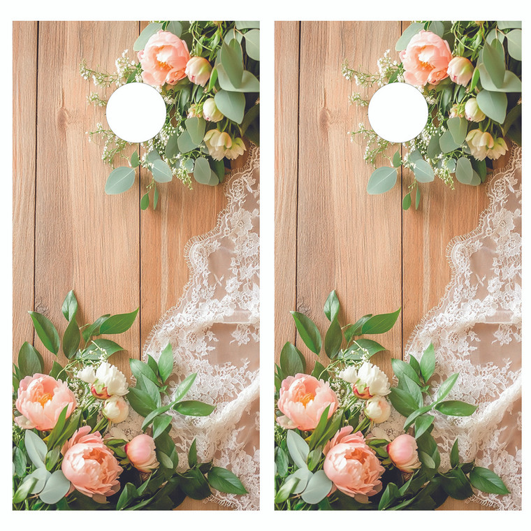 Rustic wedding design featuring soft pink peonies, lush greenery, and delicate white lace arranged over warm natural wood planks.