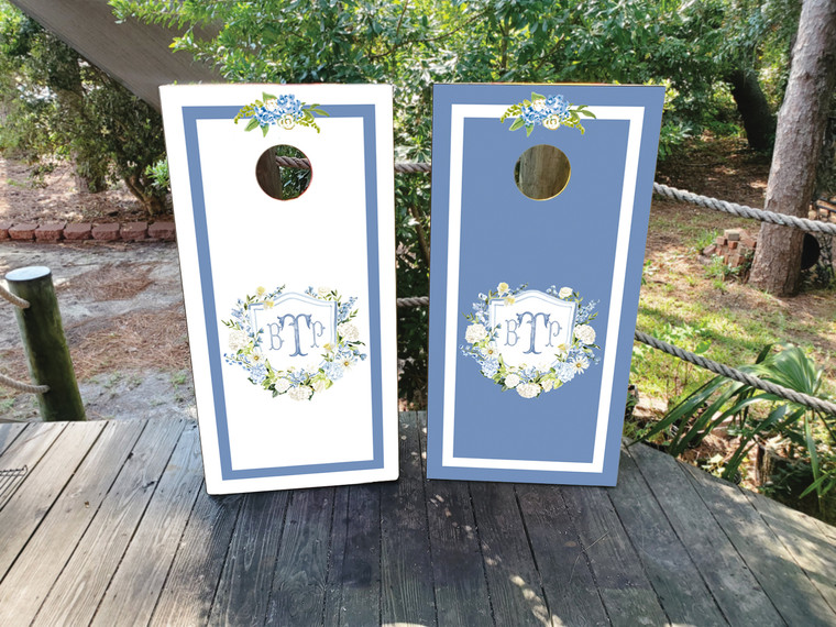 Custom cornhole wraps featuring a wedding crest