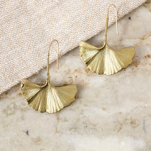 Bronze gold-toned Gingko Dangle Earrings shown on marble surface
