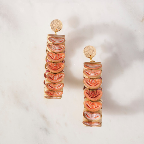 A pair of pink and tan hoop earrings made of connected heart shapes.