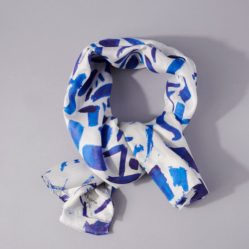 Hydrangeas Spring Song by Alma Thomas silk scarf,  white with dark blue abstract pattern, knotted, lying flat.