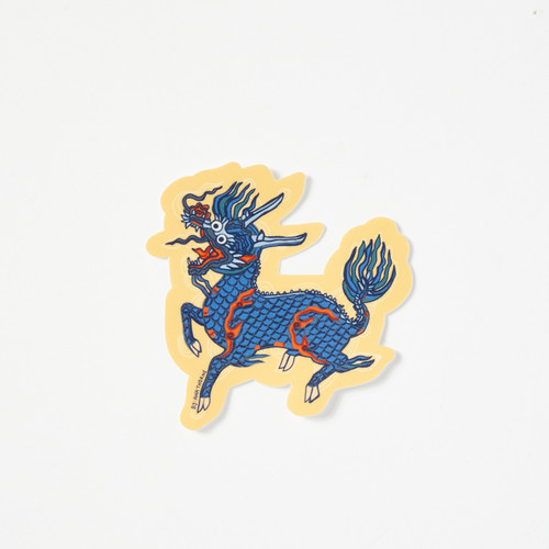 Die -cut vinyl sticker depicts a Qilin - a chimerical beast in dark blues and reds on a beige background.