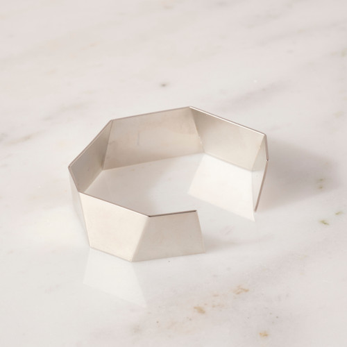 Silver-toned cuff style bracelet shown flat