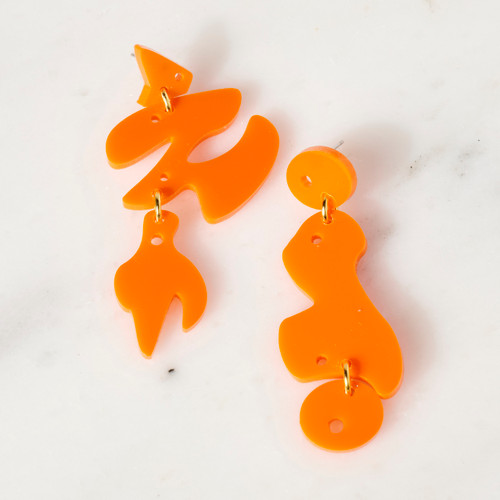 Asymmetric pair of freeform cut acetate earrings of bright orange