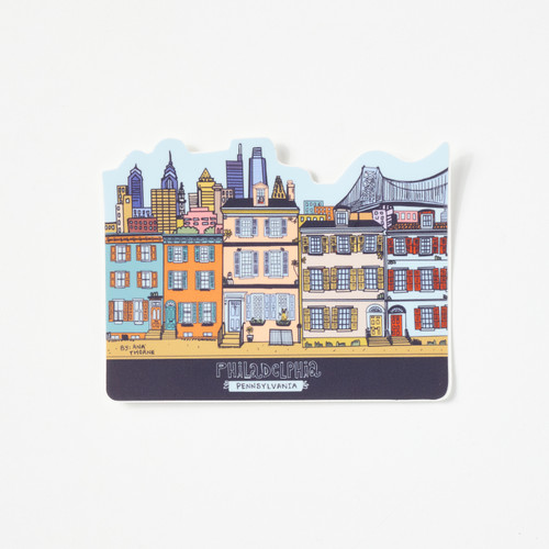 A sticker featuring a colorful drawing of a row of rowhomes with the Philadelphia skyline and the Ben Franklin Bridge in the background.