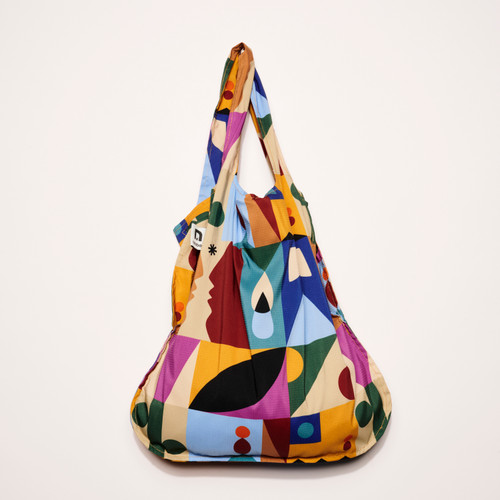 Roots multi color gridded design Convertible Backpack Tote by Notabag  shown hanging a full with cinched handles