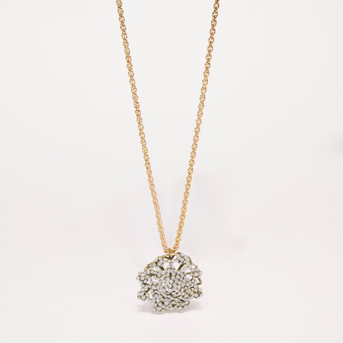 Round sparkly pendant consisting of tiny 'pedals' covered in glitter-like dust on twisted gold-tone chain