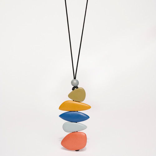 Pendant style necklace featuring a stack of 5 various shaped and colored flat smooth free-formed shapes below a smaller round bead of greyish blue; tan/yellow/blue/grey/red strung on black cording