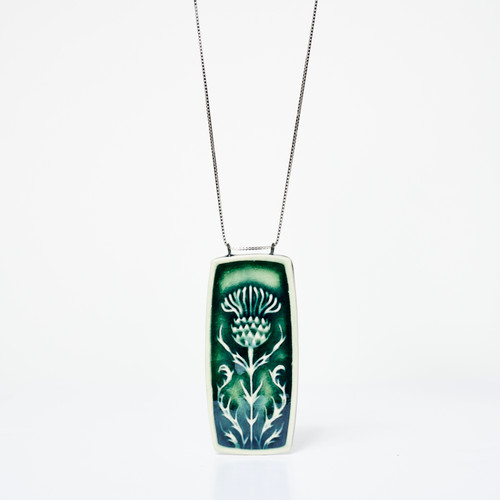 Rectangular ceramic pendant of green with debossed image of thistle plant suspended on silver chain