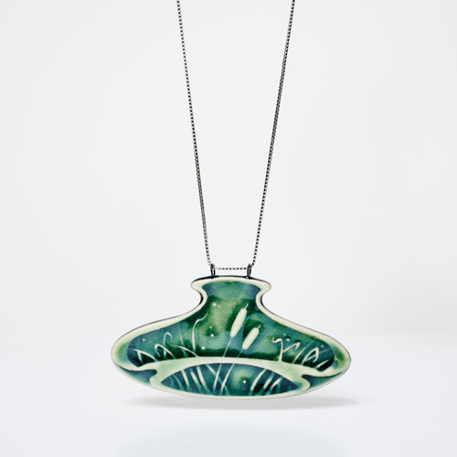 Wide oval-shaped green ceramic pendant with embossed cattail on silver chain