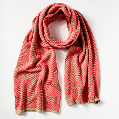 Coral and tan knit scarf shown looped