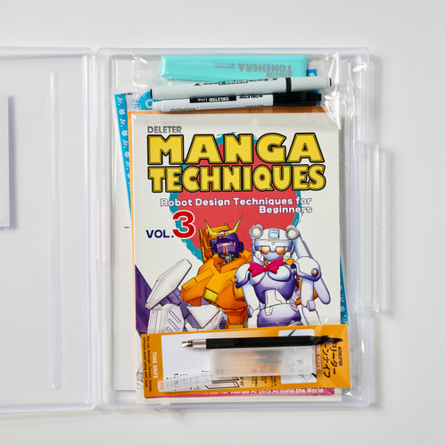 An opened plastic carrying case containing a manga-drawing instruction book and a variety of drawing tools like markers, pens, and erasers.