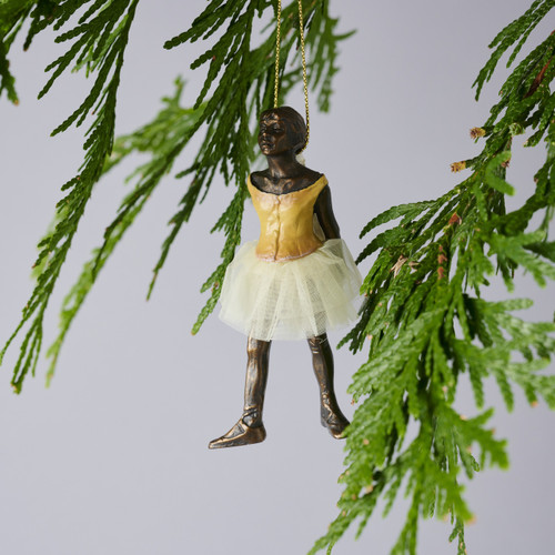 Image features the Degas Little Dancer ballerina ornament hanging from a tree branch.