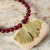detail of gold tone gingko pendant