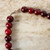 detail of lobster clasp of deep red beaded gingko necklace