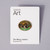 A pin made of soft enamel over base metal showing several animals in a jungle environment is pinned to a white card with Philadelphia Museum of Art branding.