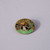 A pin made of soft enamel over base metal showing several animals in a jungle environment is shown in front of a gray background.
