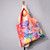 Full bleed image of Chagall's 'The Circus' printed on a tote bag shown on dress form's shoulder for scale and usage suggestion.