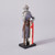 This small polystone reproduction image shows a side view of a helmeted knight in  mail armor and carrying a spear. He carries a shield, white with a red cross.  The reproduction stands atop a black square platform.