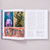 A spread of El Anatsui: Art and Life shows three paintings on the left page. The top two paintings are abstracted portraits and the bottom painting shows a group of faces emerging from a shape. The right page shows text.