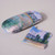 Monet's Path on the Island of Saint Martin, Vetheuil hardshell styrene-lined eyeglass case closed, with fully open microfiber cleaning cloth adjacent, side view.