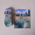 Monet's Path on the Island of Saint Martin, Vetheuil hardshell styrene-lined eyeglass case closed, with fully open microfiber cleaning cloth adjacent, front view.