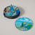 Image of Coaster set with a stack of Monet coasters in their holder and one coaster sitting alongside.