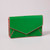 An emerald green envelope wallet with pink contrast edging stands closed on a grey surface.