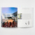 A spread of Zaha Hadid from the Basic Architecture series shows a photograph of four runners on a footrace track that passes under a skybridge between two sides of a building on the left page. On the right page, a photograph of the interior of the building shows off open spaces and bright colors next to a floorplan for the building under a text description.