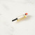 Grey, white, and black painted porcelain bird pin laying on side