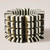 Stretch bracelet made from alternating black and cream stacked laser-cut acrylic 'BOOM' cut outs
