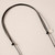 Detail of knotted black cording of necklace of oblong alternating black and cream beads arranged in a semi-circle and strung on black cording