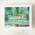 A small card featuring an image of Claude Monet's Japanese Footbridge painting and a small pair of silver dragonfly stud earrings attached to the card at the bottom right.