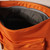 Detail of interior of orange nylon crossbody bag unzipped