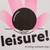 This poster detail depicts a figure facing away from the viewer, lying on his back, hands behind his head. The top of his head is black. The figure is attired in pink. Under the figure in black is the word "leisure" in small case letters followed by an exclamation point. And under that the phrase "do nothing, participate today", exclamation point.