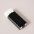 A white eraser is held inside a black aluminum holder with a metal clip.